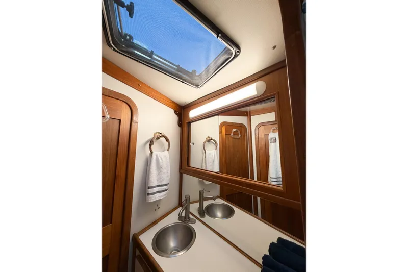 Slide: The Image of Elegant bathroom interior of 1988 Pacemaker 36 Convertible yacht with skylight and dual sinks. - 91