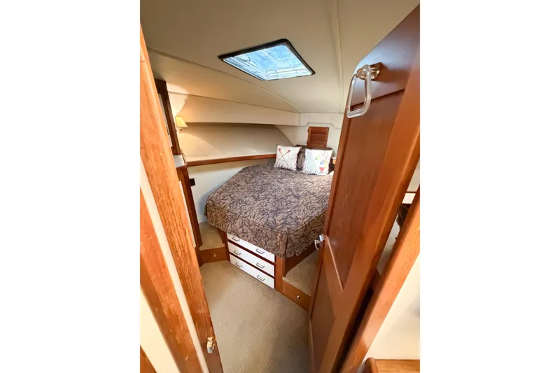 Slide: The Image of Cozy cabin interior of 1988 Pacemaker 36 Convertible yacht with bed and skylight. - 92