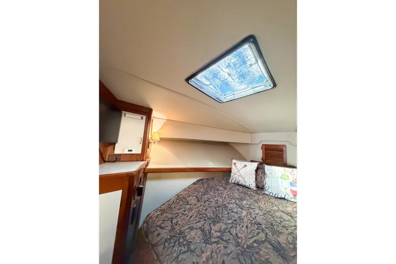 Slide: The Image of Cozy cabin interior of 1988 Pacemaker 36 Convertible yacht with skylight and bedding. - 94