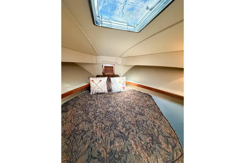 Slide: The Image of Cozy cabin interior of 1988 Pacemaker 36 Convertible with skylight and decorative pillows. - 96
