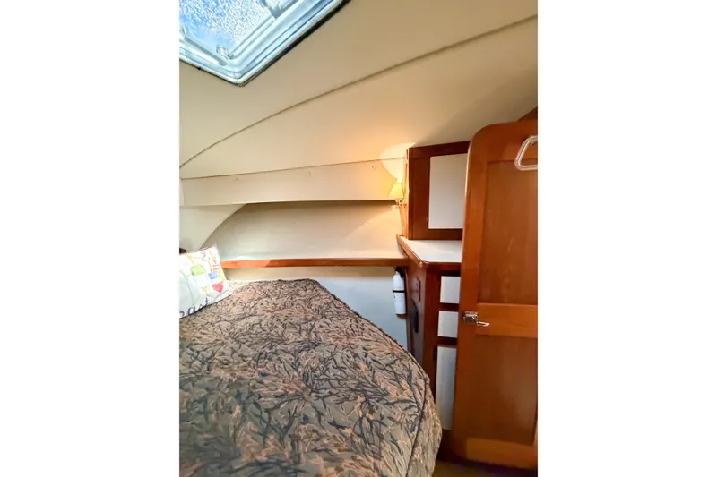 Slide: The Image of Cozy cabin interior of 1988 Pacemaker 36 Convertible yacht with bed and wooden cabinetry. - 97