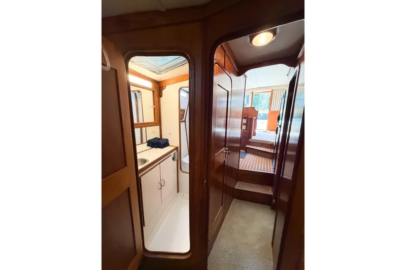 Slide: The Image of Interior view of 1988 Pacemaker 36 Convertible yacht, featuring a compact bathroom and wooden cabinetry. - 99