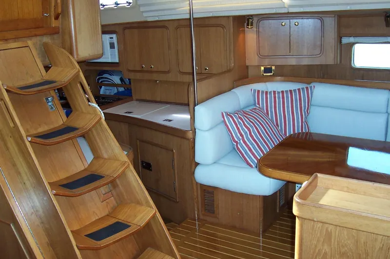 Slide: The Image of Luxurious 1994 C&C 51' XL yacht interior with wooden cabinetry and cozy seating area. - 11