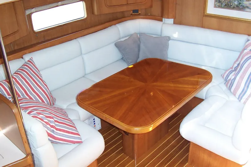 Slide: The Image of Luxurious 1994 C&C 51' XL yacht interior with elegant wood table and plush seating. - 13