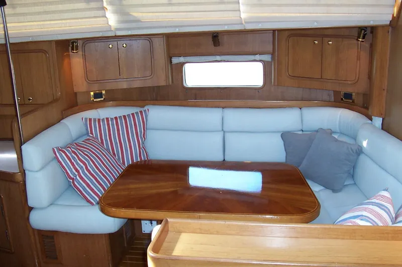 Slide: The Image of Cozy interior of 1994 C&C 51' XL yacht with cushioned seating and wooden table. - 14