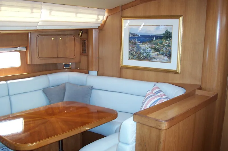 Slide: The Image of Luxurious 1994 C&C 51' XL yacht interior with wood paneling and cozy seating area. - 16