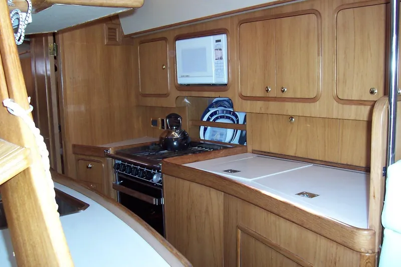 Slide: The Image of Interior of 1994 C&C 51' XL / CB yacht kitchen with wooden cabinetry and appliances. - 21