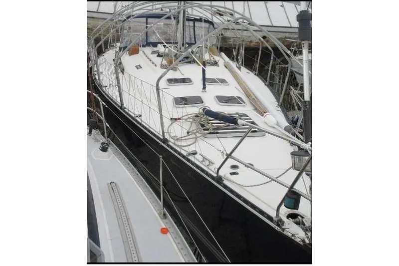 Slide: The Image of 1994 C&C 51' XL / CB sailboat docked, featuring sleek design and spacious deck. - 31