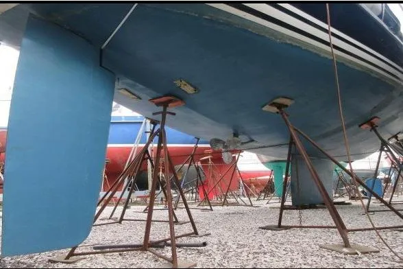 Slide: The Image of 1994 C&C 51' XL / CB sailboat on stands, showcasing hull and rudder. - 39