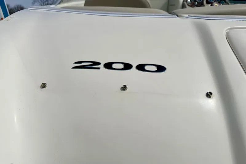 Slide: The Image of 2003 Sea Ray 200 Sundeck boat with visible model number on white surface. - 13