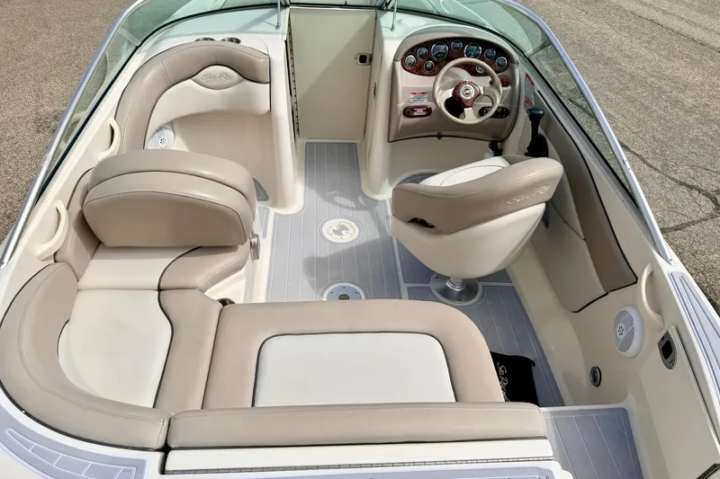 Slide: The Image of Interior view of a 2003 Sea Ray 200 Sundeck boat with beige seating and dashboard. - 14