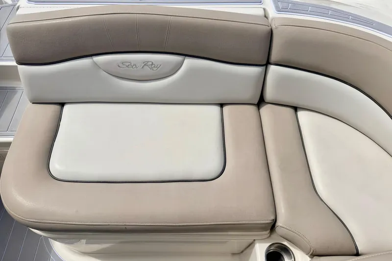 Slide: The Image of 2003 Sea Ray 200 Sundeck boat seating, featuring beige and white cushioned upholstery. - 18