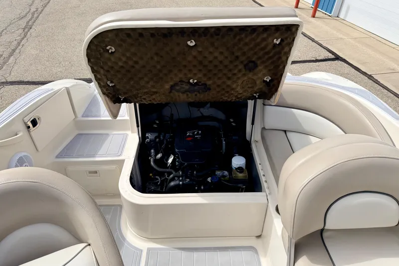 Slide: The Image of 2003 Sea Ray 200 Sundeck boat engine compartment with open hatch, showcasing interior details. - 20
