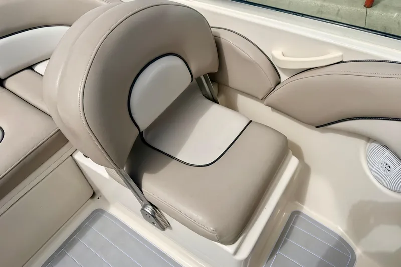 Slide: The Image of 2003 Sea Ray 200 Sundeck boat seat, beige upholstery, sleek design. - 23