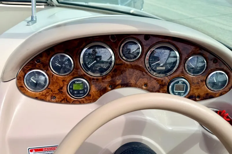 Slide: The Image of Dashboard of a 2003 Sea Ray 200 Sundeck boat with gauges and controls. - 28