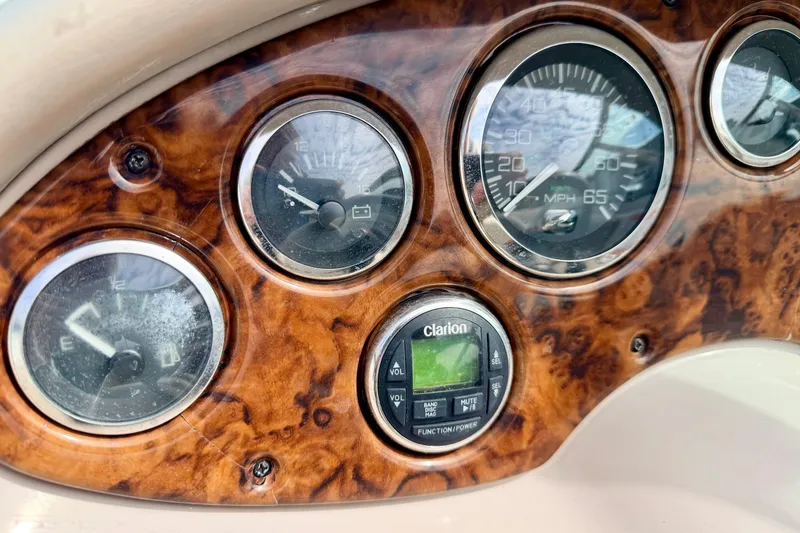 Slide: The Image of Dashboard of 2003 Sea Ray 200 Sundeck with gauges and Clarion audio system. - 29