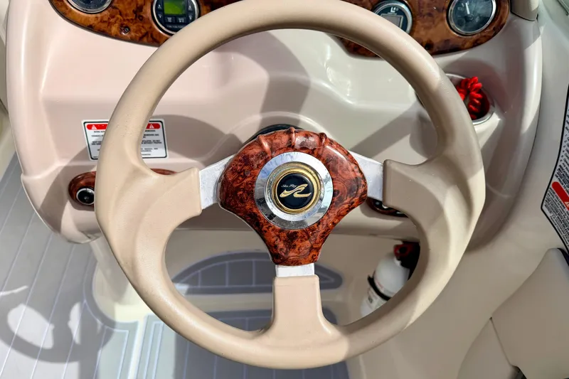 Slide: The Image of Steering wheel of a 2003 Sea Ray 200 Sundeck boat with wood accents. - 31