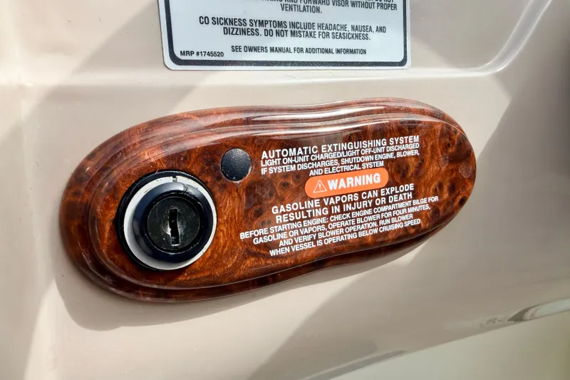Slide: The Image of 2003 Sea Ray 200 Sundeck ignition switch with safety warning label. - 32