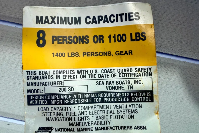 Slide: The Image of 2003 Sea Ray 200 Sundeck capacity label, 8 persons or 1100 lbs, U.S. Coast Guard compliant. - 34