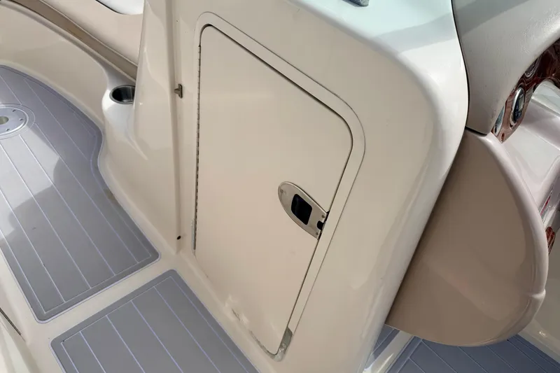 Slide: The Image of 2003 Sea Ray 200 Sundeck interior with storage compartment and non-slip flooring. - 36