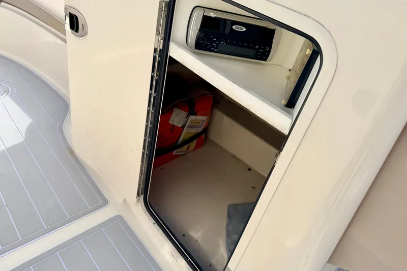 Slide: The Image of Storage compartment on a 2003 Sea Ray 200 Sundeck boat with stereo system. - 37