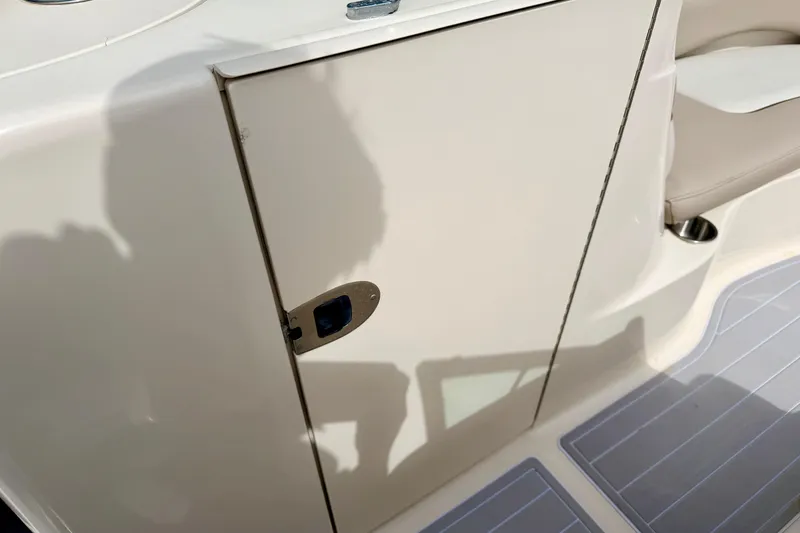 Slide: The Image of 2003 Sea Ray 200 Sundeck boat interior with storage compartment and seating area. - 40