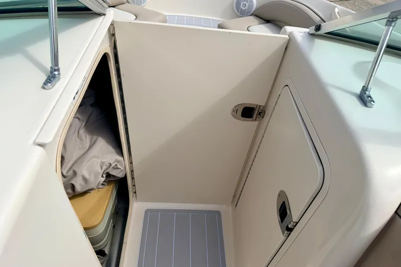 Slide: The Image of 2003 Sea Ray 200 Sundeck interior storage compartment with door and cushion. - 42