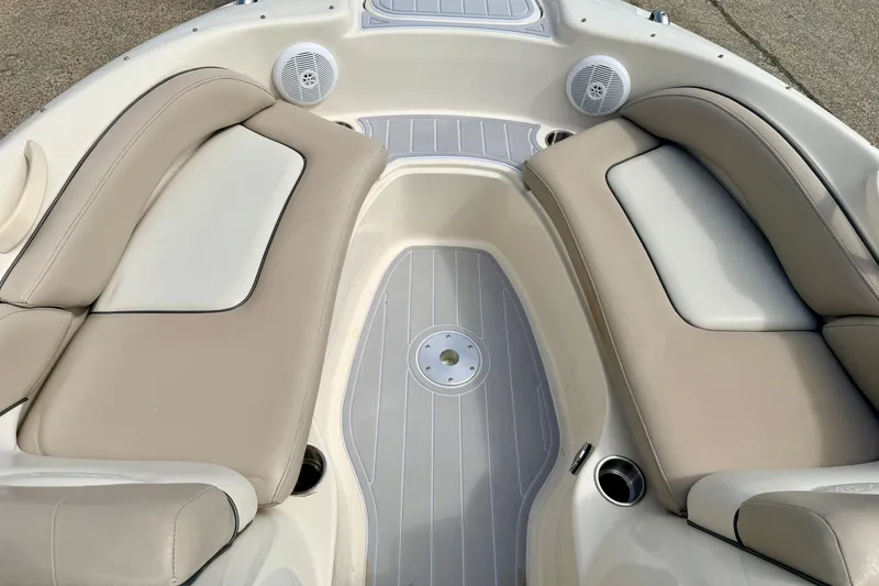 Slide: The Image of Interior seating of 2003 Sea Ray 200 Sundeck boat with beige cushions and speakers. - 43