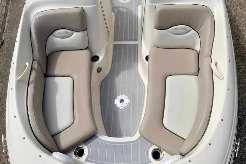 Slide: The Image of 2003 Sea Ray 200 Sundeck boat interior with beige and gray seating. - 44