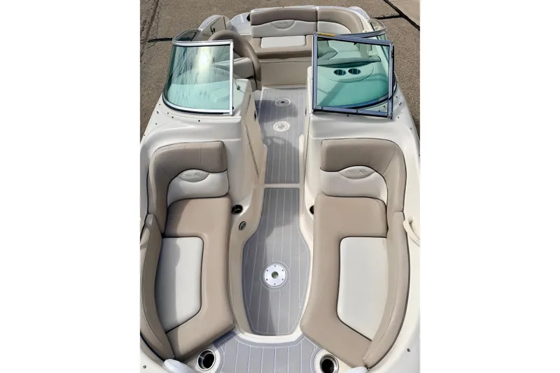 Slide: The Image of 2003 Sea Ray 200 Sundeck boat interior with beige seating and windshield. - 45