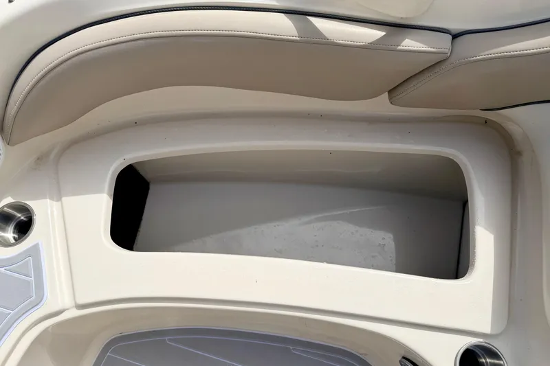 Slide: The Image of Storage compartment on a 2003 Sea Ray 200 Sundeck boat, featuring beige seating. - 47