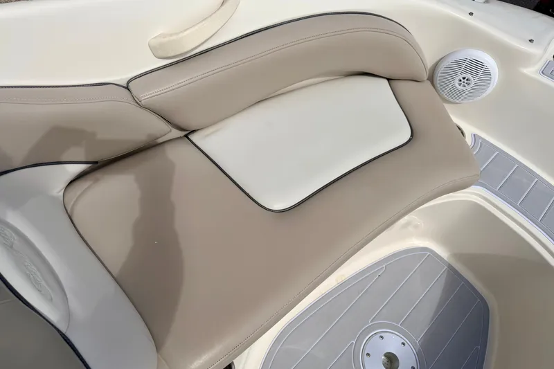 Slide: The Image of 2003 Sea Ray 200 Sundeck boat interior with beige seating and speaker detail. - 48