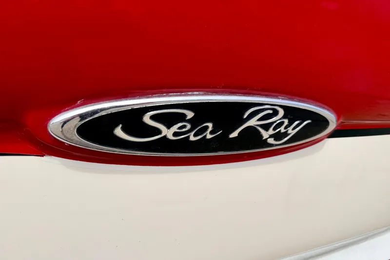 Slide: The Image of Close-up of 2003 Sea Ray 200 Sundeck logo on red and white surface. - 5
