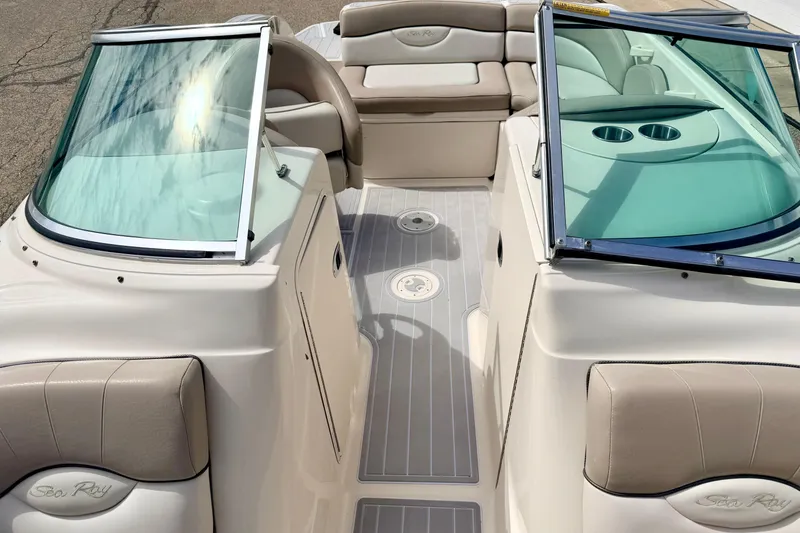 Slide: The Image of 2003 Sea Ray 200 Sundeck interior with seating and windshield, showcasing luxury boat design. - 54