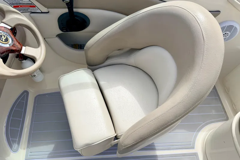 Slide: The Image of Captain's seat and steering wheel of 2003 Sea Ray 200 Sundeck boat. - 57