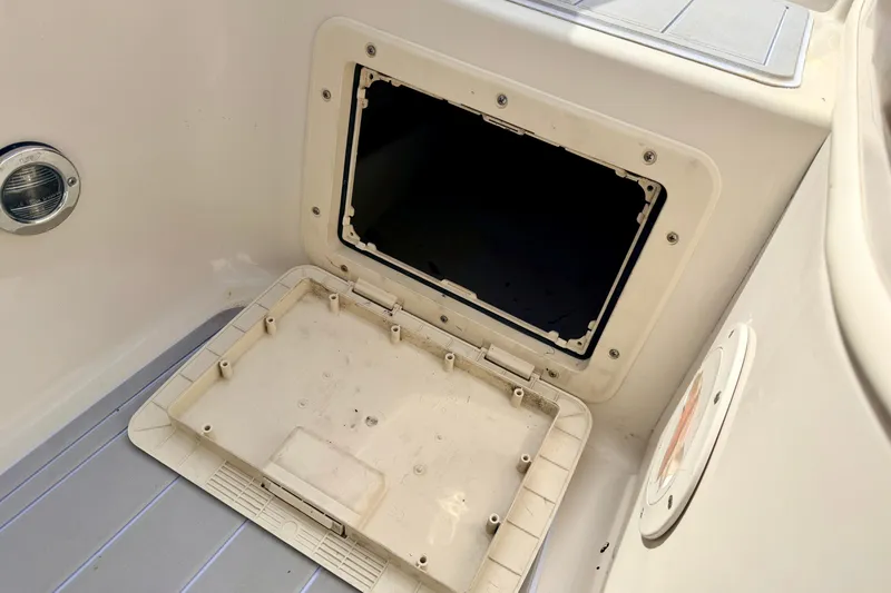 Slide: The Image of Open storage compartment on a 2003 Sea Ray 200 Sundeck boat interior. - 60