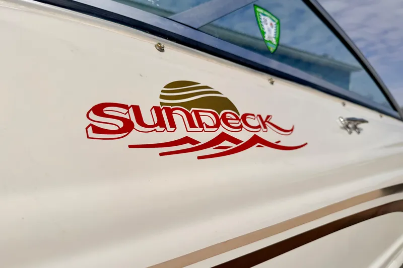 Slide: The Image of Close-up of 2003 Sea Ray 200 Sundeck boat logo on the side. - 64