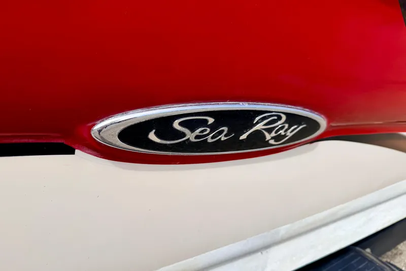 Slide: The Image of Close-up of 2003 Sea Ray 200 Sundeck logo on red and white boat. - 65