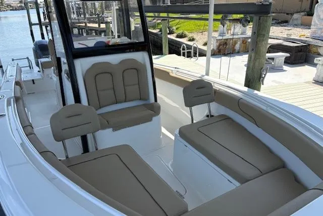 Slide: The Image of 2017 Sea Hunt Gamefish 25 boat interior with tan seating and spacious deck. - 7