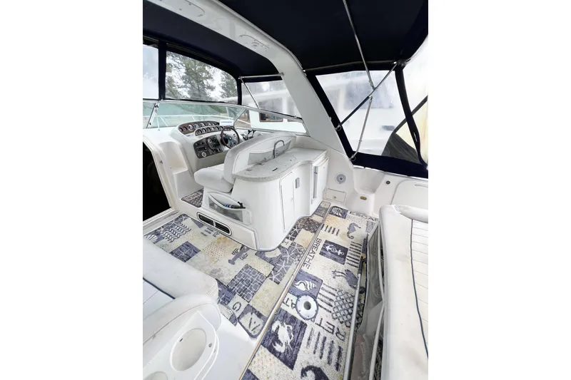 Slide: The Image of Interior of 2000 Rinker Fiesta Vee 330 boat with patterned carpet and steering console. - 10