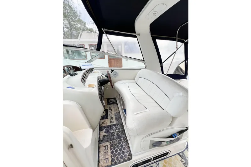 Slide: The Image of Interior of 2000 Rinker Fiesta Vee 330 boat with white seating and dashboard. - 12