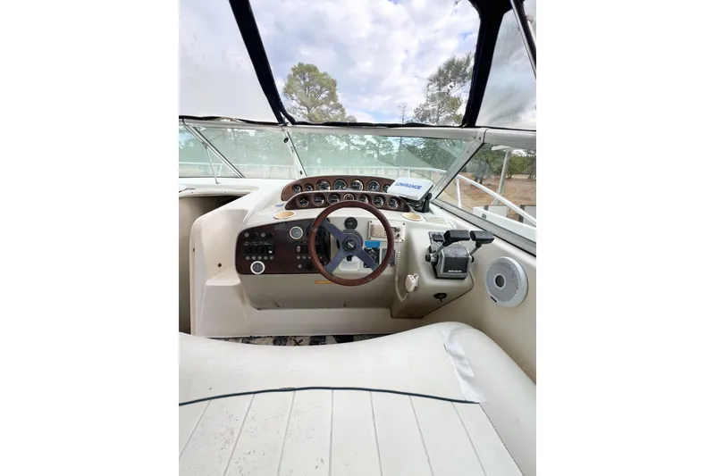 Slide: The Image of Cockpit of 2000 Rinker Fiesta Vee 330 boat with steering wheel and control panel. - 15