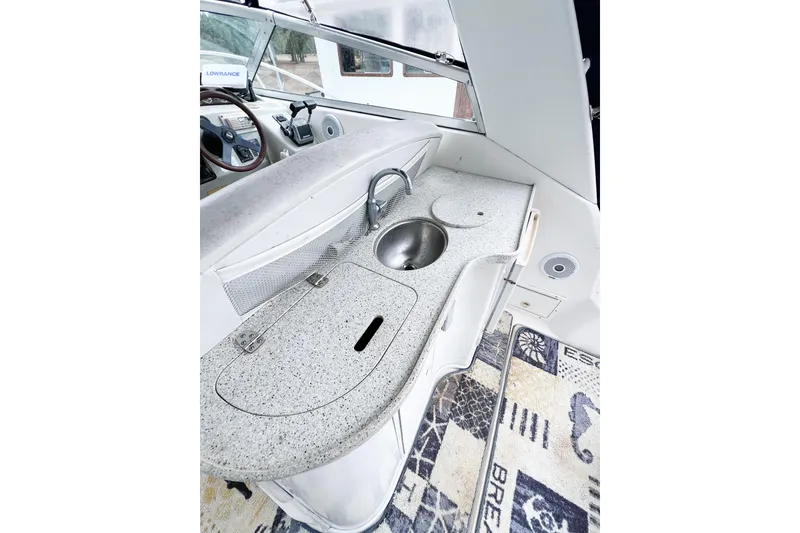 Slide: The Image of 2000 Rinker Fiesta Vee 330 boat interior with kitchenette and sink. - 16