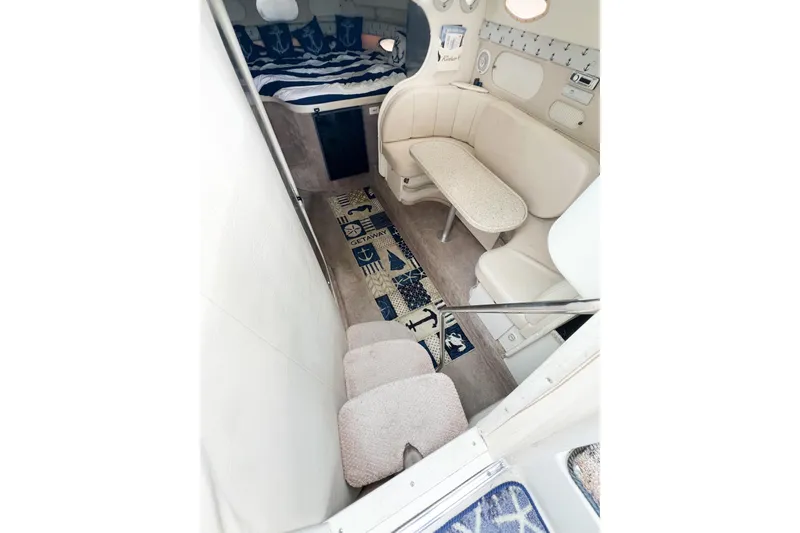 Slide: The Image of Interior of 2000 Rinker Fiesta Vee 330 boat with seating and nautical decor. - 18