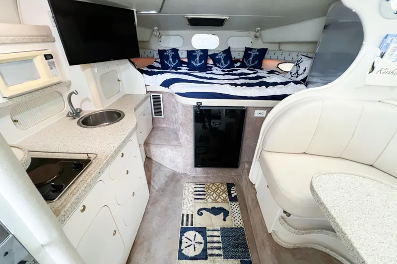 Slide: The Image of Interior of 2000 Rinker Fiesta Vee 330 boat with kitchenette and cozy sleeping area. - 20
