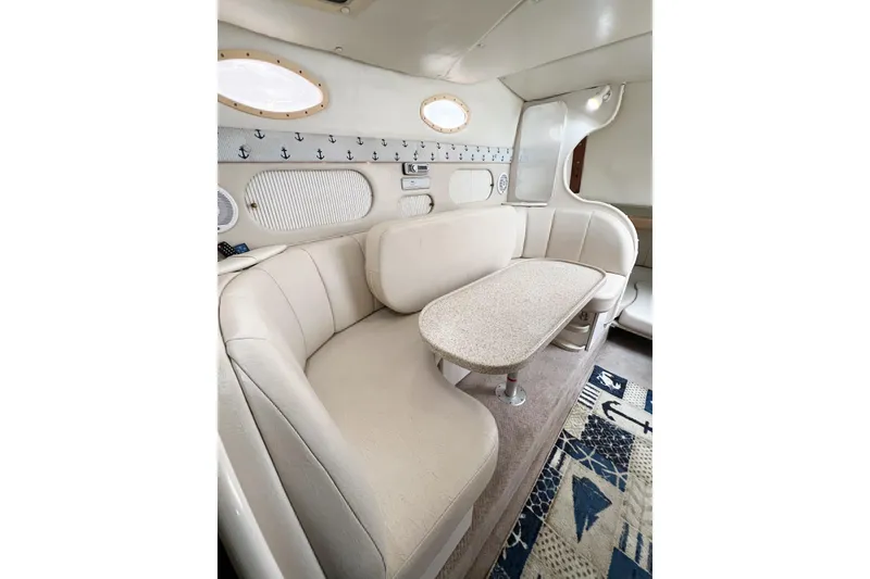 Slide: The Image of Interior of 2000 Rinker Fiesta Vee 330 boat with cozy seating and nautical decor. - 27