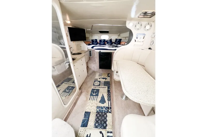 Slide: The Image of Interior of 2000 Rinker Fiesta Vee 330 boat with cozy seating and nautical decor. - 29
