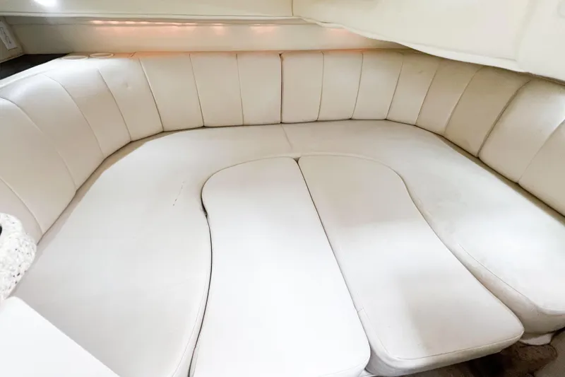 Slide: The Image of Interior seating of 2000 Rinker Fiesta Vee 330 boat, featuring white upholstery. - 31