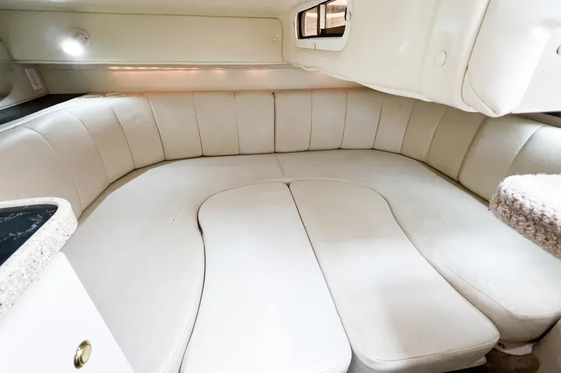 Slide: The Image of Interior cabin of 2000 Rinker Fiesta Vee 330 with white seating and cozy design. - 32