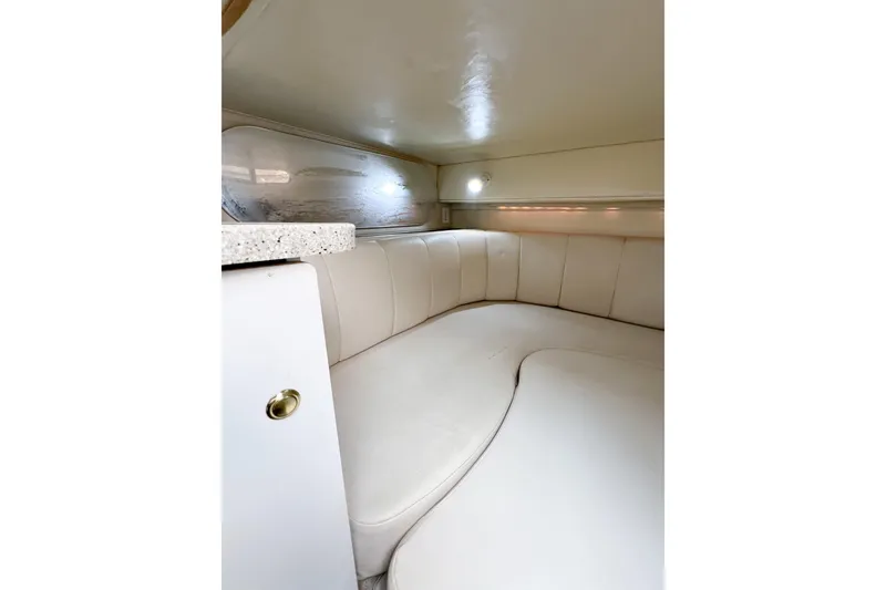 Slide: The Image of Interior cabin of 2000 Rinker Fiesta Vee 330 with white cushioned seating. - 33